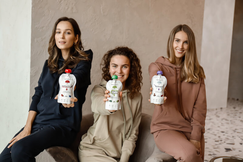 three women smiling holding Startuper's Smoothies organic meal replacements